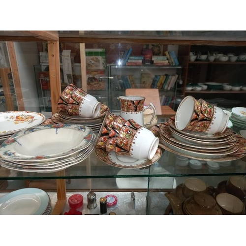 235 - A shelf of various porcelain dinner & tea ware