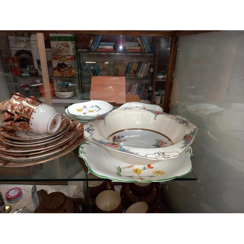 235 - A shelf of various porcelain dinner & tea ware