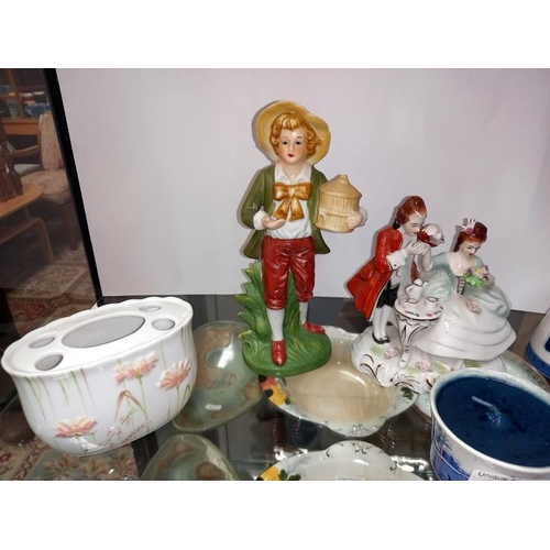 243 - A shelf of decorative porcelain figurines etc.