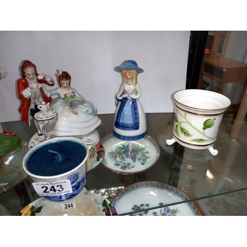 243 - A shelf of decorative porcelain figurines etc.