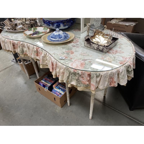 430 - A French style curved dressing table with cloth apron and glass cover