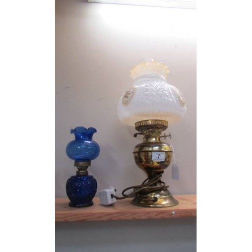 7 - A brass table lmap with glass shade and a blue glass oil lamp.