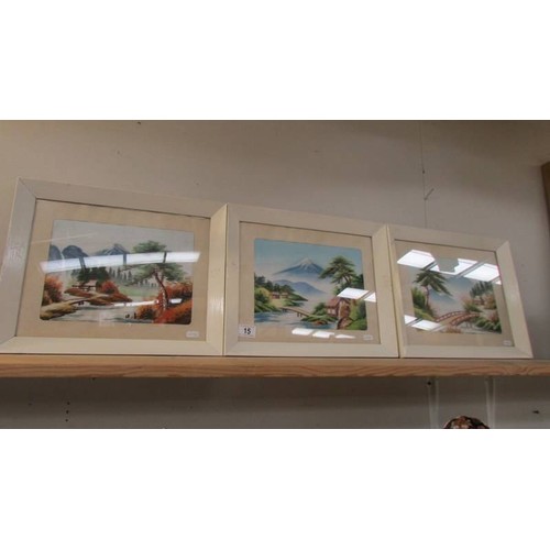 15 - Three framed and glazed mountain scenes on silk.