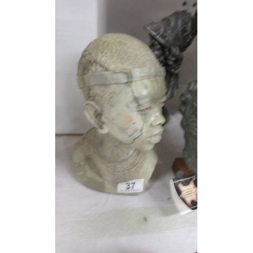 37 - An African bust, a Roman soldier bust, one other bust and a Buddha.