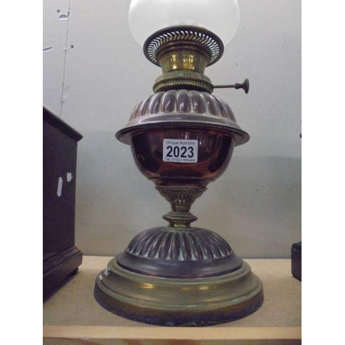 2023 - A brass oil lamp with later etched glass shade. COLLECT ONLY.