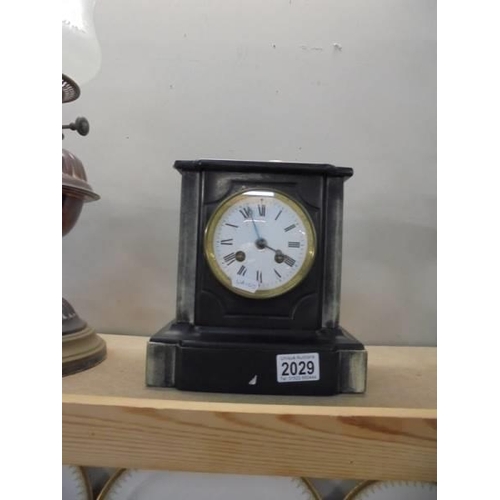 2029 - A heavy black mantel clock.