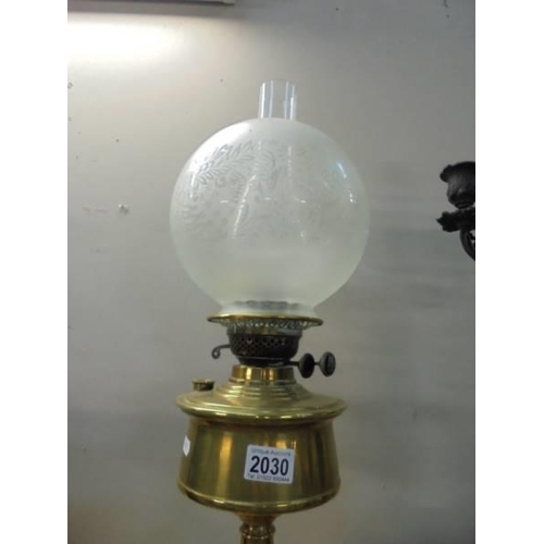 2030 - A brass oil lamp with later etched glass shade. COLLECT ONLY.