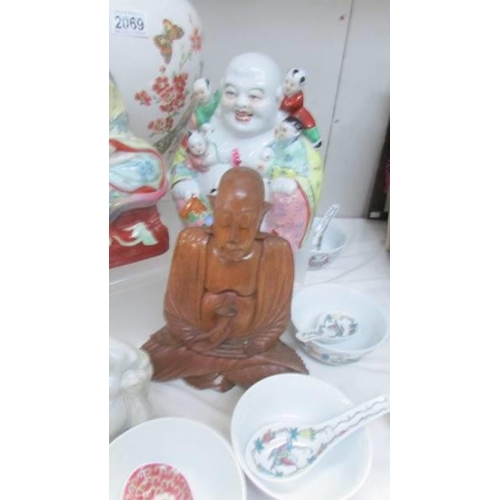 2069 - Three Buddha figures, an large Chinese vase, rice bowls and spoons.