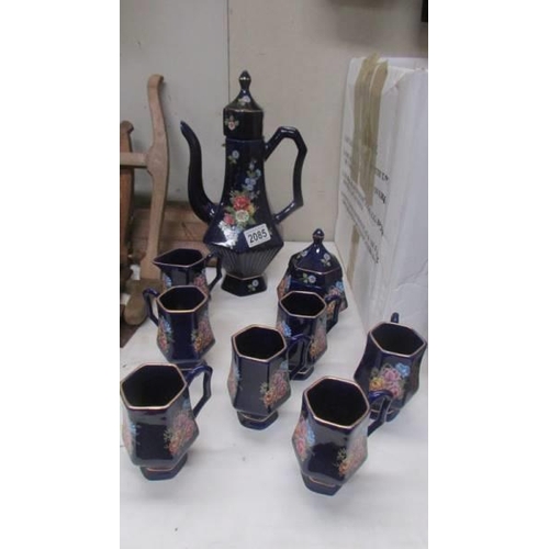 2085 - A hand painted blue ceramic coffee set.