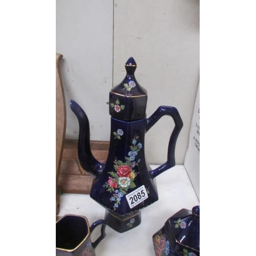 2085 - A hand painted blue ceramic coffee set.