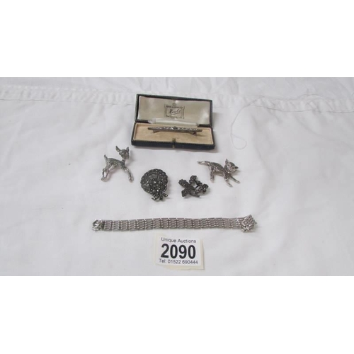 2090 - A silver bracelet, two silver marcasite brooches and three other brooches.