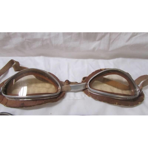 2098 - Three metal trays depicting scenes of Bolton and 2 pairs of vintage goggles.