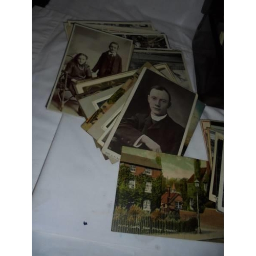 2103 - A mixed lot of old postcards and photographs in a mahogany box.