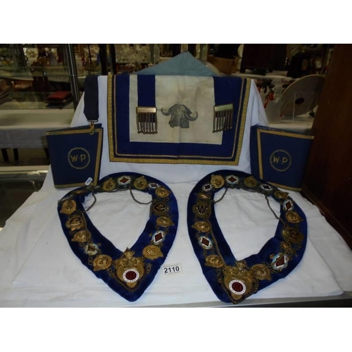 2110 - Two Masonic collars, a Masonic apron and a pair of cuffs.