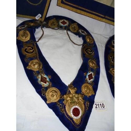 2110 - Two Masonic collars, a Masonic apron and a pair of cuffs.