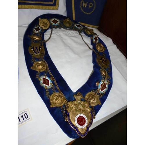 2110 - Two Masonic collars, a Masonic apron and a pair of cuffs.