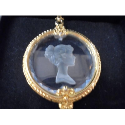 2143 - An engraved glass pendant in yellow metal mount.