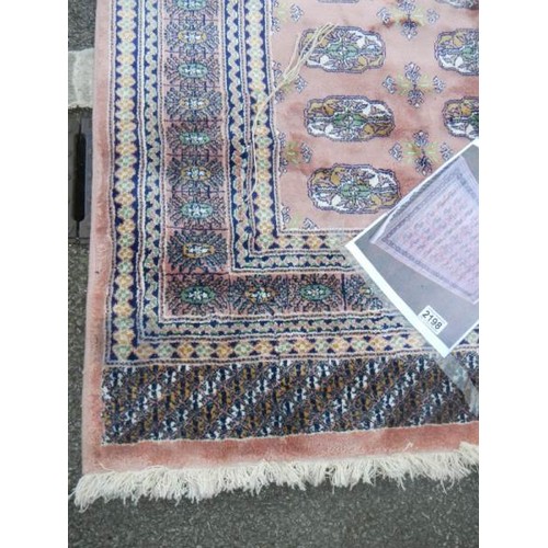 2198 - A pink patterned rug.