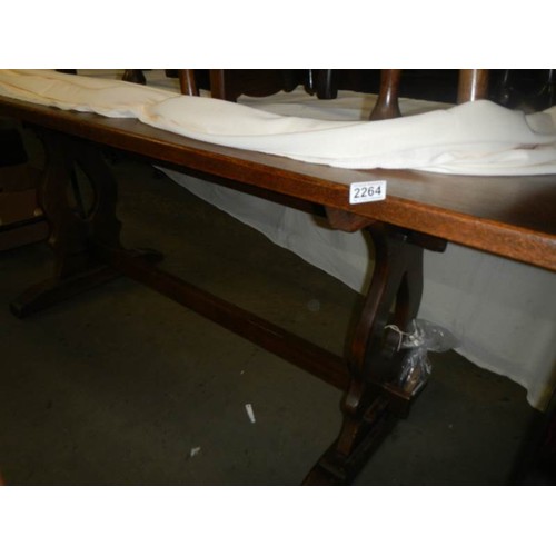 2264 - A long oak dining table and a set of six pad foot chairs, COLLECT ONLY.