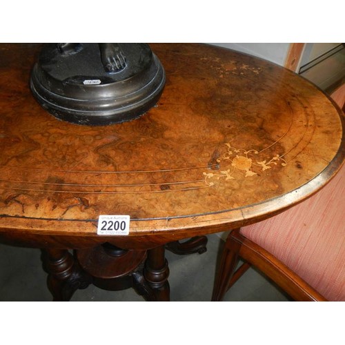 2200 - An oval mahogany inlaid table with birdcage base. COLLECT ONLY.