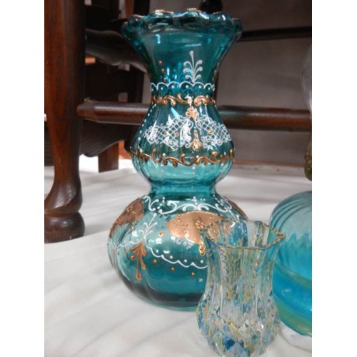 2354 - A Victorian blue glass hand oil lamp, a blue glass vase and a small vase.