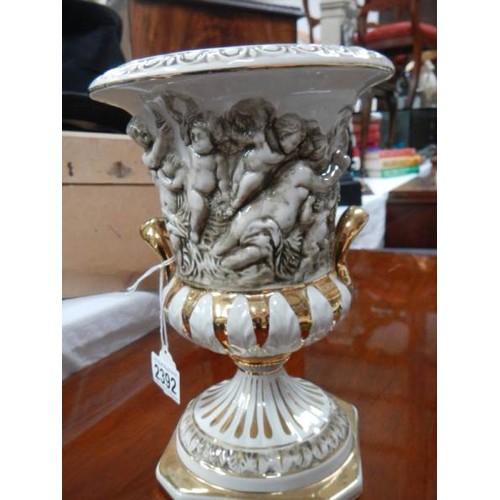 2392 - A decorative urn with applied figures.