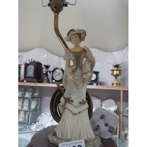 2409 - A figural table lamp with large shade.