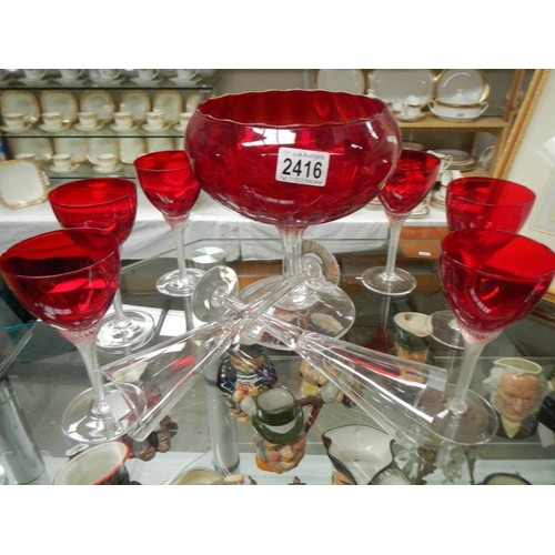 2416 - A large red glass bowl, set of 6 red glasses and two other glasses.