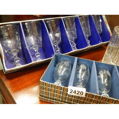 2420 - A cut glass decanter and 2 boxed sets of glasses.