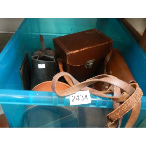 2434 - A box of leather camera cases, collar boxes etc.,