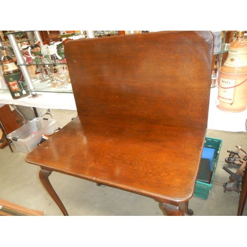 2438 - A mahogany fold over table. COLLECT ONLY.