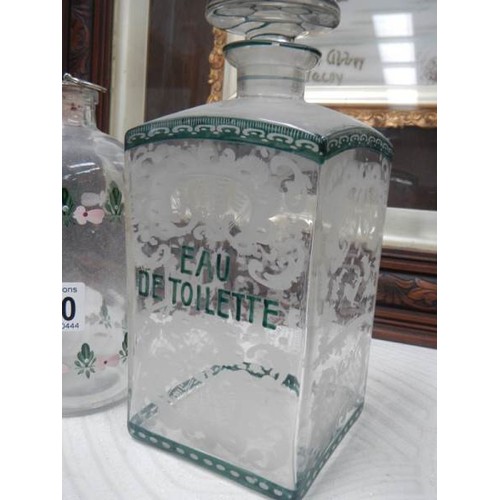 2480 - A pair of early French etched bathroom bottles and one other.