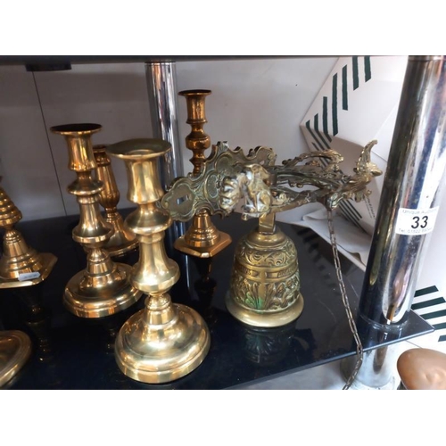 33 - A good selection of brassware including candlesticks, ink well & plane ornaments etc.