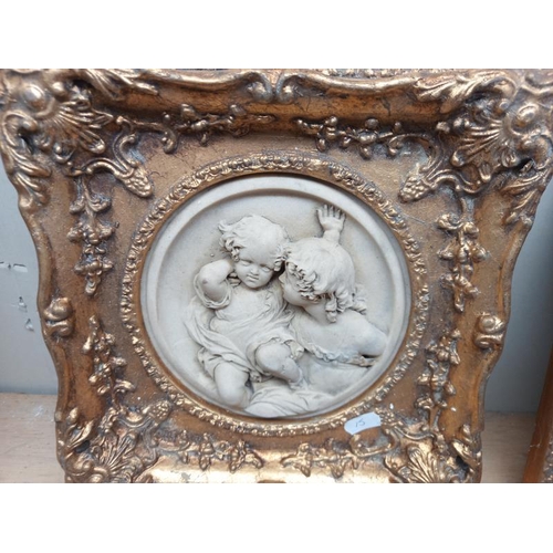 20 - 2 gilt framed classical resin plaques of children (28cm x 28cm)