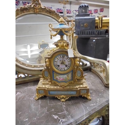 1593 - A French style ormolu clock with Sevres panels.