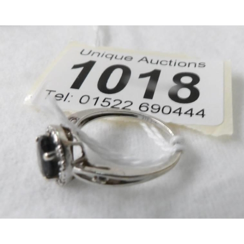 1018 - An oval sapphire and diamond white gold ring, size J half, 1.6 grams/