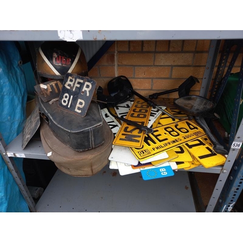 536 - 2 motorcycle seats, a quantity of  American & British number plates and a vintage helmet etc.
Collec... 