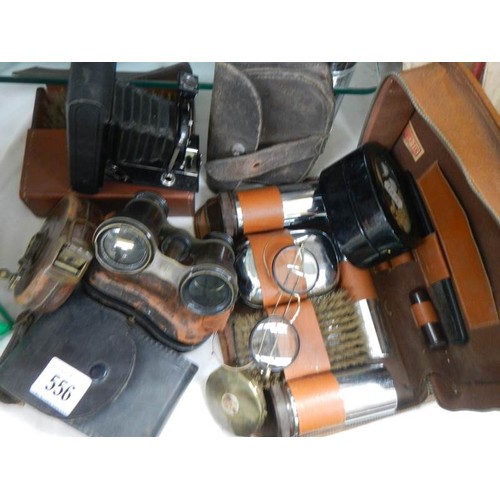 556 - A mixed lot of leather cased shaving sets, binoculars, camera etc.,