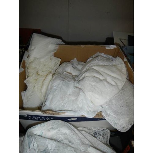 585 - A large box of net curtains etc.,