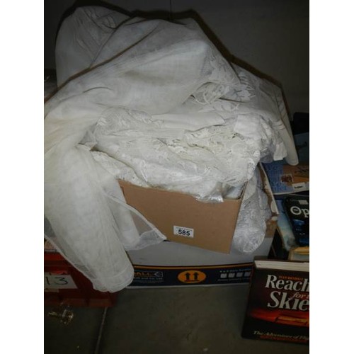 585 - A large box of net curtains etc.,