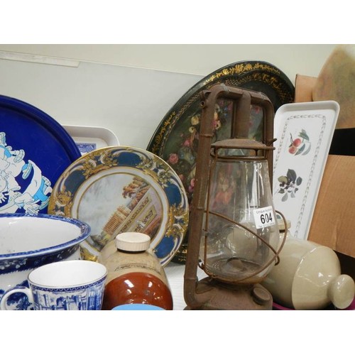 604 - A mixed lot including water bottles, metal trays, blue and white etc.,