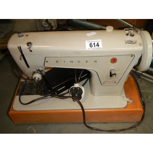 614 - A Singer sewing machine with tatty cover COLLECT ONLY.