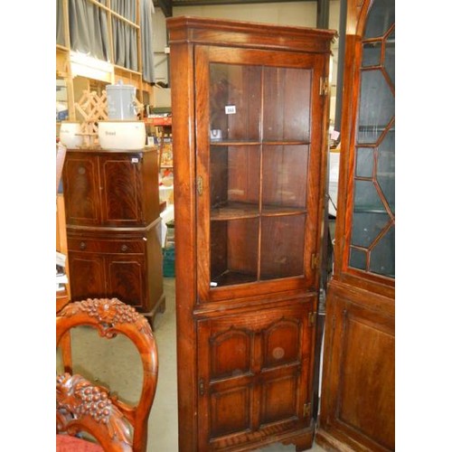 668 - A 20th century oak panelled top corner cupboard, COLLECT ONLY.