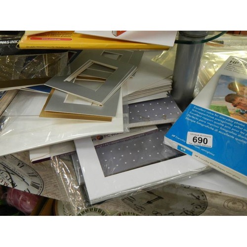 690 - Two shelves of picture mounts and photo paper.