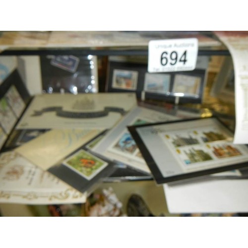 694 - Two shelves of collector's stamps.