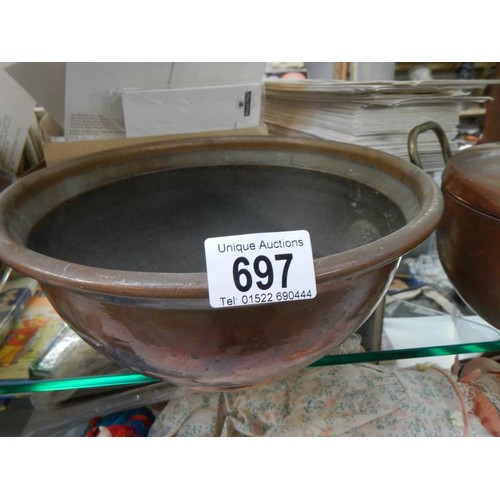 697 - Three old copper bowls etc.,