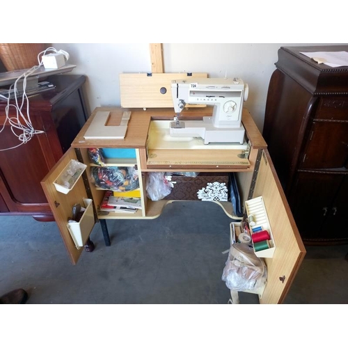 728 - An electric sewing machine in cabinet with contents. Collect Only.