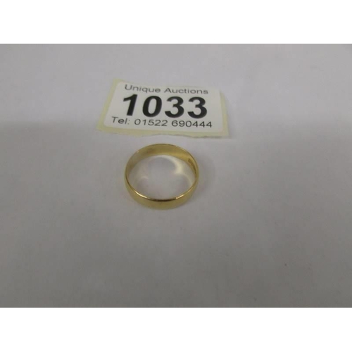 1033 - A 22ct gold wedding ring, size O, 3.3 grams.