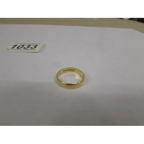 1033 - A 22ct gold wedding ring, size O, 3.3 grams.