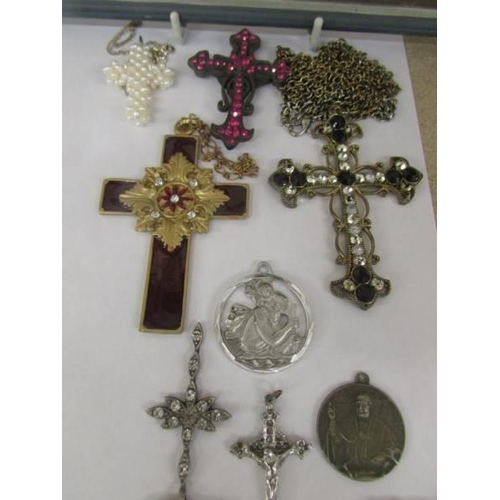 1035 - A mixed lot of cross pendants, St. Christophers etc., and a small picture of the Last Supper.